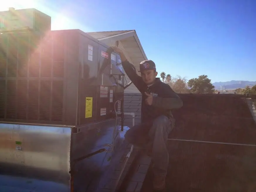 HVAC technician performing AC Tune-Up on a rooftop unit in Temple Terrace